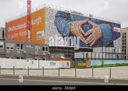 Large poster of the CDU German Chancellor Angela Merkel,  with a typical attitude called the 'Merkel rhombus', Berlin Stock Photo