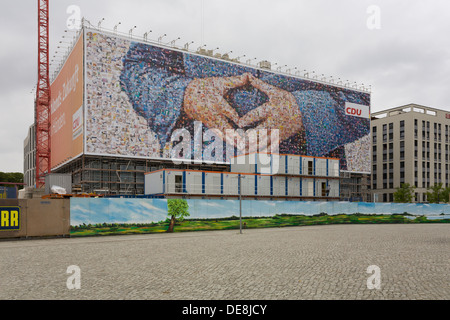 Large poster of the CDU German Chancellor Angela Merkel,  with a typical attitude called the 'Merkel rhombus', Berlin Stock Photo