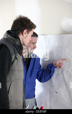 craftsman and young apprentice working together Stock Photo