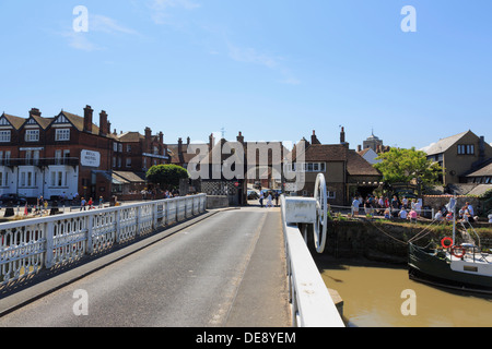 View along iron swing toll bridge over River Stour to Barbican Gate in Cinque Port town of Sandwich, Kent, England, UK, Britain Stock Photo