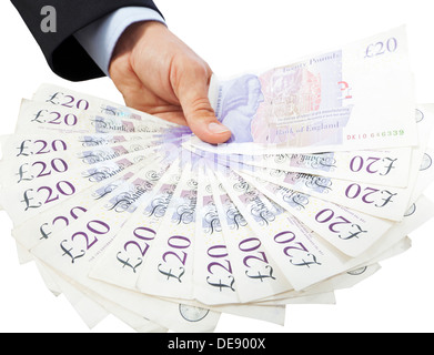 Close-up of a hand holding a fan of twenty pound notes against a white background. Stock Photo
