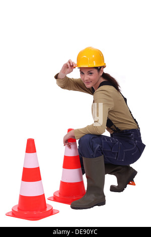 Woman placing traffic cones Stock Photo