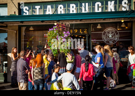 Crowd of people surrounding the original Starbucks Coffee Shop at Pike Place Market, Seattle Washington USA Stock Photo