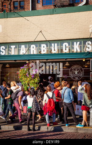 Crowd of people surrounding the original Starbucks Coffee Shop at Pike Place Market, Seattle Washington USA Stock Photo