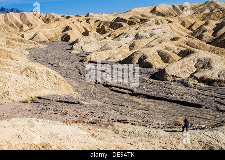 Distant photographer along the Golden Canyon trail near Zabriskie Point, Death Valley National Park, California USA Stock Photo