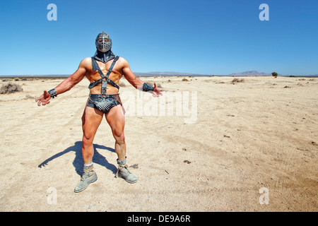 John Grimm dressed as Mad Max movie character Humungus (left), at the Wasteland Weekend in the Mojave Desert, USA Stock Photo