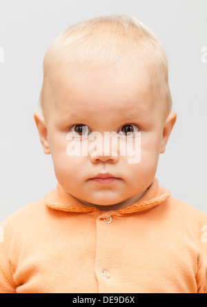 Closeup studio face portrait of Caucasian baby girl isolated on gray background Stock Photo