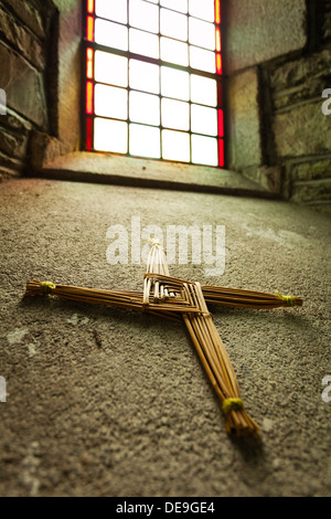 Traditional St Brigids cross made from weaving strands of straw together on a window sill in St Brigids cathedral, Kildare, Irel Stock Photo