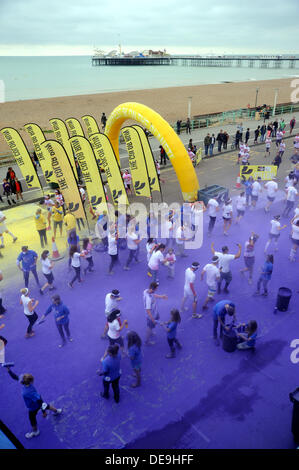 Brighton Sussex UK 14 September 2013 -Thousands of people taking part in the Dulux Color Run along Brighton seafront today Stock Photo