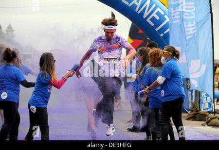 Brighton Sussex UK 14 September 2013 -Thousands of people taking part in the Dulux Color Run along Brighton seafront today Stock Photo