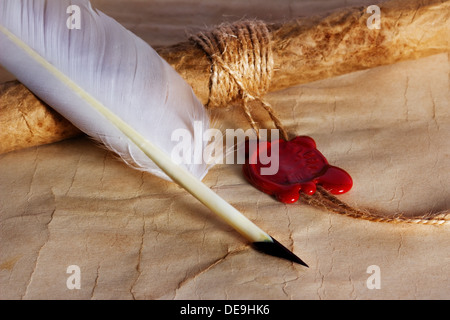 old paper, ancient parchment scroll with wax seal and quill pen Stock Photo