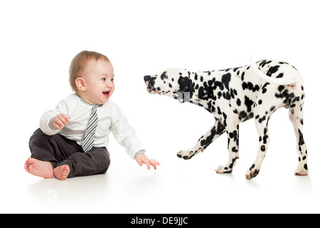 baby boy playing with puppy dog Stock Photo