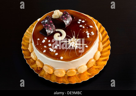 Delicious tiramisu cake on a golden plate Stock Photo