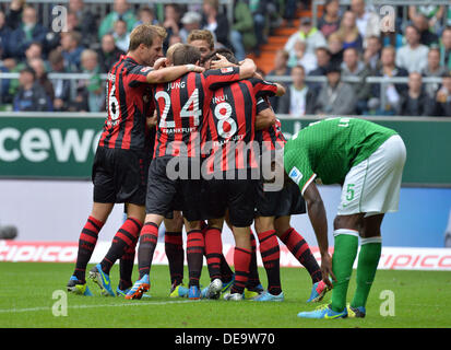 Bremen, Germany. 14th Sep, 2013. Frankfurt's Sebastian Rode (L), Stefan Aigner (R) and Takashi Inui celebrate Vaclac Kadlec's (covered) 0-1 goal during the German Bundesliga match between Werder Bremen and Eintracht Frankfurt at Weser Stadium in Bremen, Germany, 14 September 2013. Photo: CARMEN JASPERSEN/dpa/Alamy Live News Stock Photo