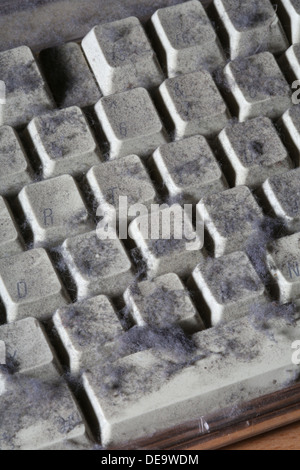 unused computer keyboard covered in dust and cobwebs Stock Photo