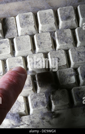 unused computer keyboard covered in dust and cobwebs Stock Photo