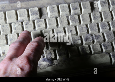 unused computer keyboard covered in dust and cobwebs Stock Photo