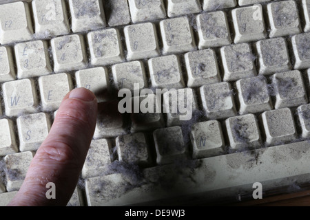 unused computer keyboard covered in dust and cobwebs Stock Photo