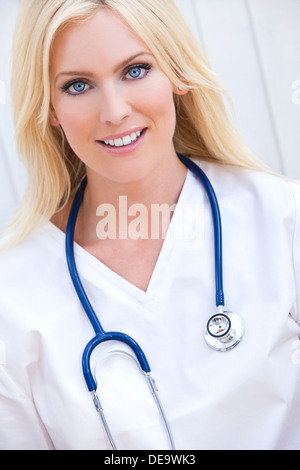 Happy, smiling, female hospital doctor or nurse with stethoscope Stock Photo