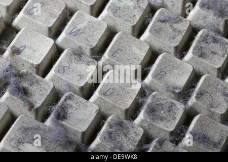 unused computer keyboard covered in dust and cobwebs Stock Photo