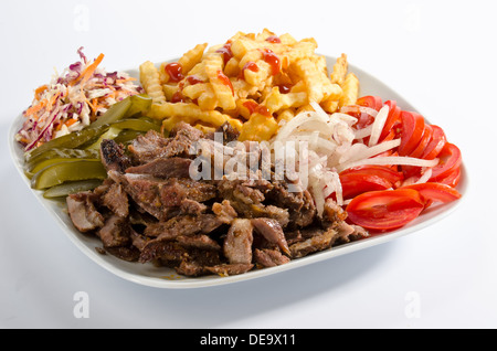 Doner kebab on a plate with french fries and salad Stock Photo