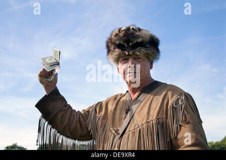 Ingleton, UK 14th September, 2013. Davy Crockett holding American dollars at Ingleton's Wild West Weekend featuring the American Civil War Society with living history displays and re-enactments.  Union and Confederate Soldiers wearing the uniforms and carrying the weapons of the period. Stock Photo