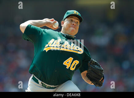 Oakland A's pitcher Bartolo Colon throws to the Seattle Mariners