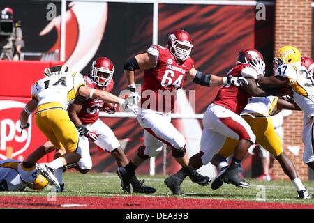 Sept. 14, 2013: Razorback center Travis Swanson #64 works to clear a ...