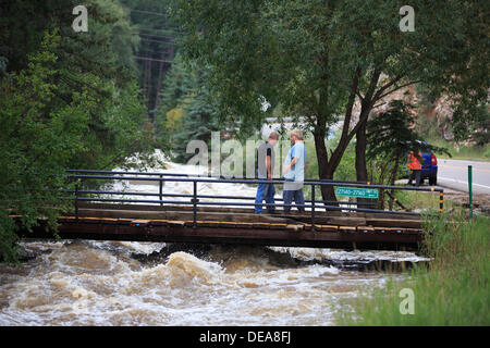 Evergreen, CO USA.  14 Sept, 2013. Residents along Hwy 74 inspect a bridge over Bear Creek to their home amongst the massive flooding  Evergreen is expected to receive more rain through Sunday. © Ed Endicott  Alamy Live News Stock Photo
