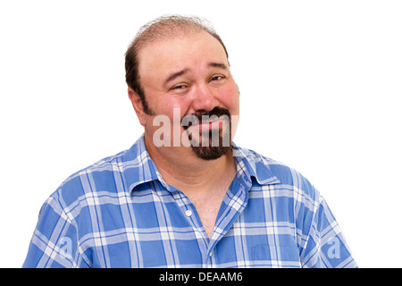 Overweight man with a goatee beard and a skeptical expression looking at the camera with his eyebrows raised in distrust Stock Photo