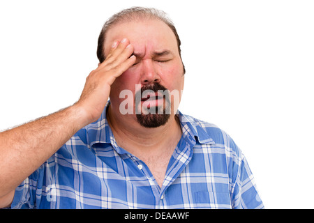 Portrait of a middle-aged man experiencing a headache, isolated on white background Stock Photo