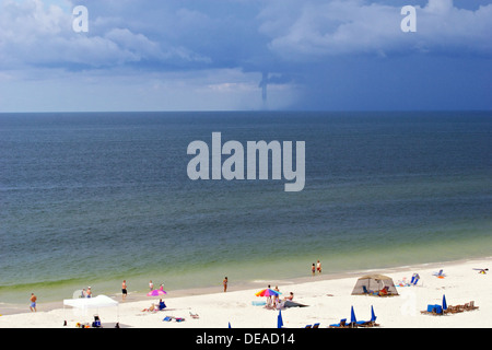 water cyclone forming in the Atlantic ocean with people on beach watching Stock Photo