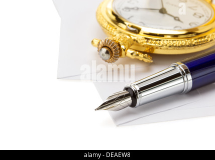 watch and pen at envelope isolated on white background Stock Photo