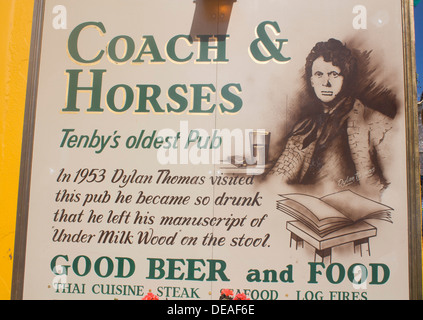 Dylan Thomas portrait and story on sign outside Coach & Horses pub Tenby Pembrokeshire Wales UK Stock Photo