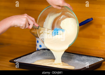 Pouring batter, preparation of stuffed cake Stock Photo