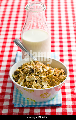 muesli and milk on checkered tablecloth Stock Photo