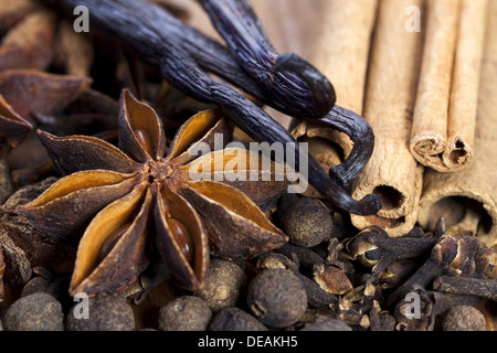Assortment of Christmas spices on wooden Board as Close Up View Stock Photo