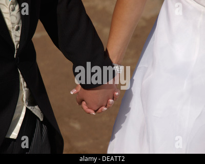Newly weds holding hands, UK 2013 Stock Photo