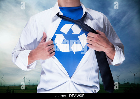 Businessman with open short revealing shirt with recycling symbol underneath Stock Photo