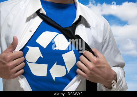 Businessman with open short revealing shirt with recycling symbol underneath Stock Photo