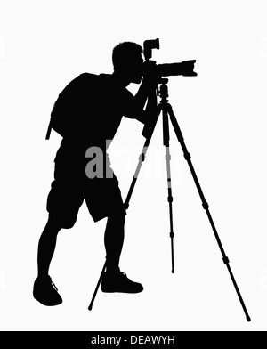 Silhouette of man taking pictures with camera on tripod. Stock Photo