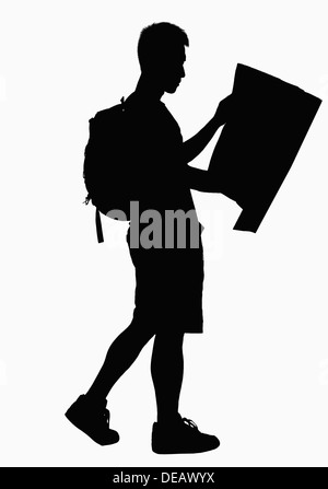 Silhouette of man looking at map. Stock Photo