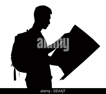 Silhouette of man looking at map. Stock Photo