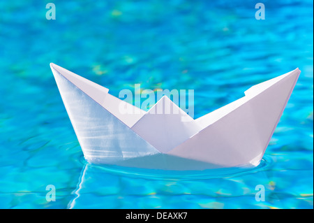 paper boat on the water in the pool Stock Photo