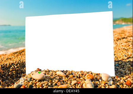 blank sheet of paper on a beach against the sea Stock Photo