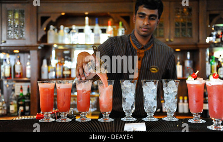 Bartender at Raffles hotel in Singapore making the famous Singapore sling cocktail drink Stock Photo