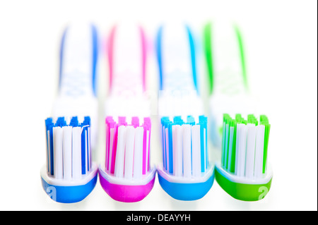 four new multi-colored toothbrushes are on a white background Stock Photo