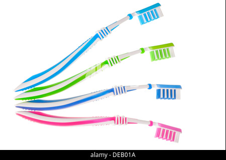 four new multi-colored toothbrushes are on a white background Stock Photo
