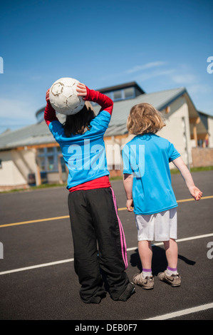 Pupils playing games at breaktime in a primary school, Wales UK Stock Photo