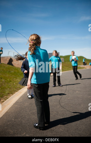 Pupils child children playing games at breaktime in a primary school, Wales UK Stock Photo